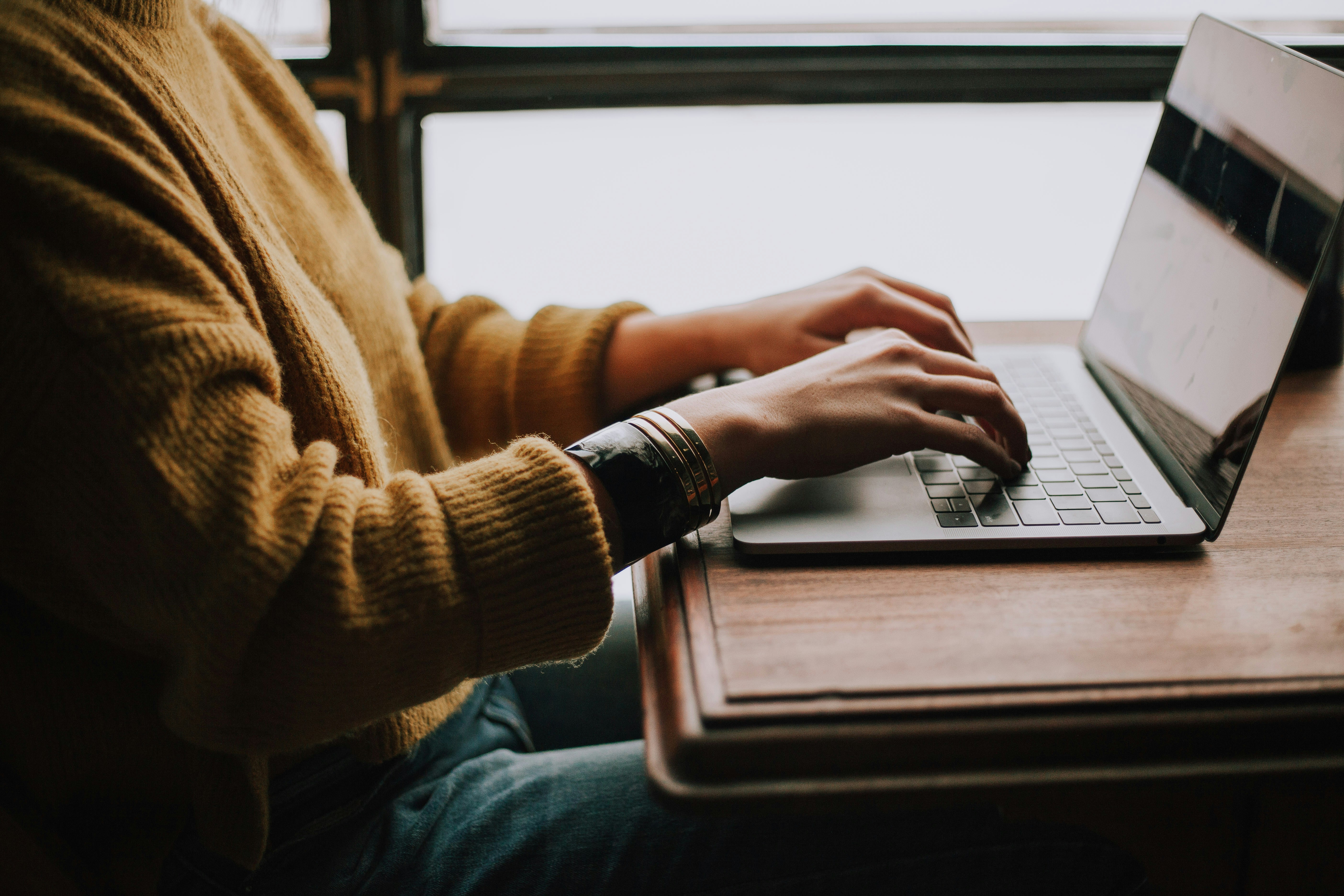 laptop screen and a scentence says 'I design and develop experiences that make people's lives simple' is wrote on it